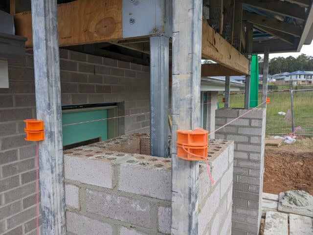 MAGSY magnetic line blocks holding string line on brick wall under construction
