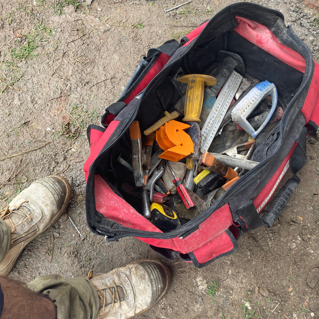 Bricklayer’s tool bag containing MAGSY - an essential masonry tools for site setup and alignment