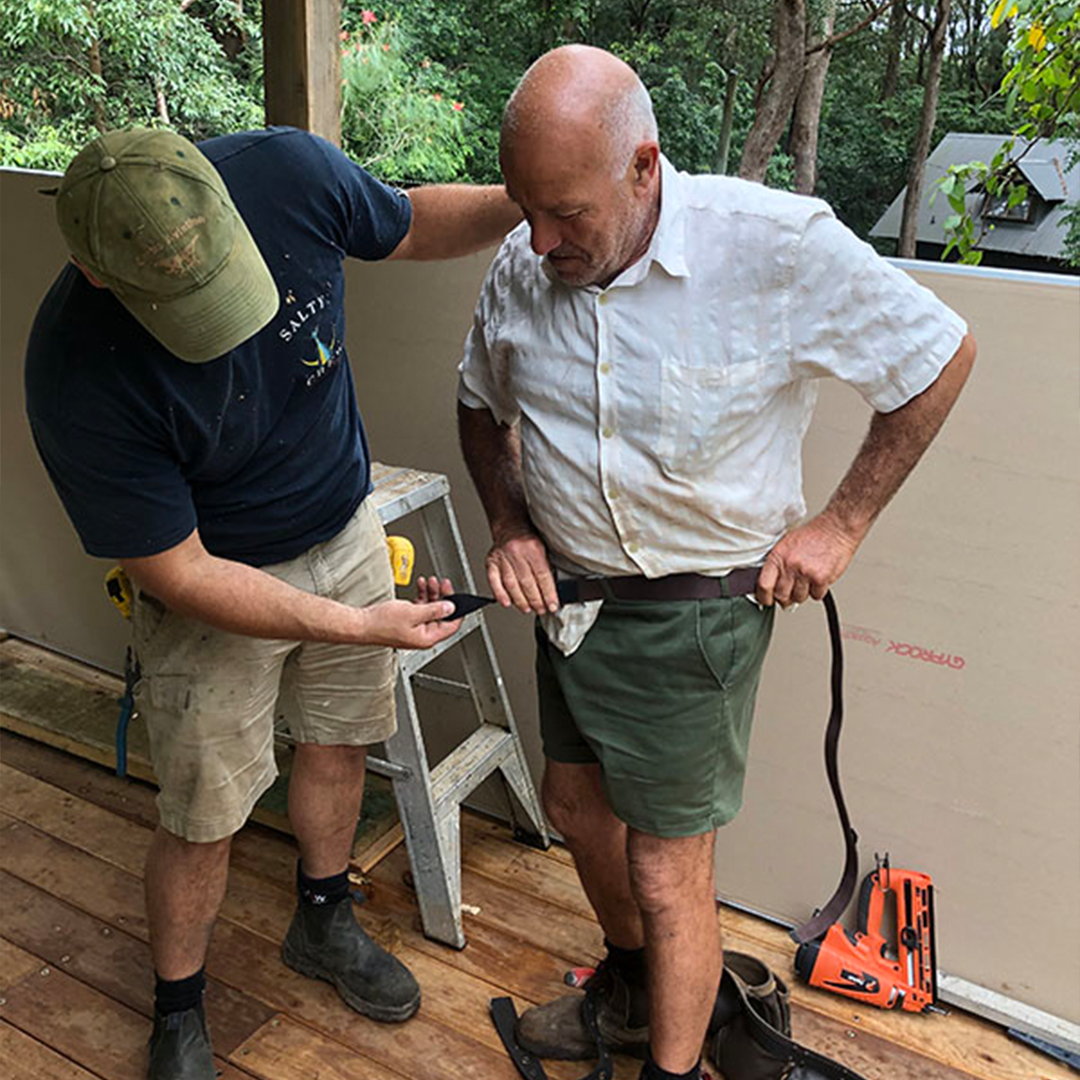 Tradies Gear belt being fitted on a man, with assistance from another person, demonstrating adjustability and ease of use.Fits all shapes adn sizes