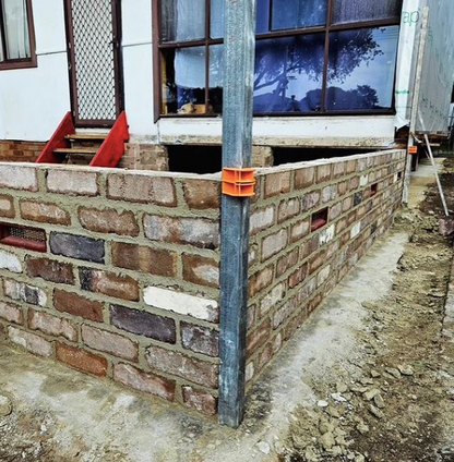 Brick wall under construction using Tradies Gear MAGSY magnetic corner blocks for precise string line setup in masonry work