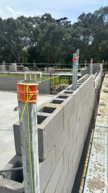 Accurate bricklaying tool for running long string lines on concrete block work at a commercial build site